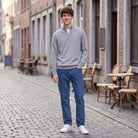 Man wearing grey half-zip jumper with blue jeans on cobblestone street | Chaps London