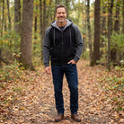 Man wearing black zip hoodie with gray contrast sleeves on trail | Chaps London