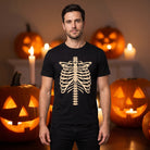 Man wearing black t-shirt with ribcage skeleton print, Halloween pumpkins background | Chaps London