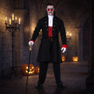 Man wearing black vampire jacket with red jabot, holding cane, Halloween setting | Chaps London