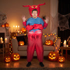 Man wearing inflatable red devil costume with horns in spooky room | Chaps London
