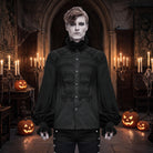 Man wears black pleated gothic shirt with ruffled collar, Halloween castle setting | Chaps London