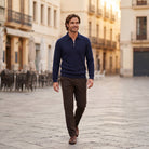 Man wearing navy half-zip knit polo jumper with brown trousers outdoors | Chaps London