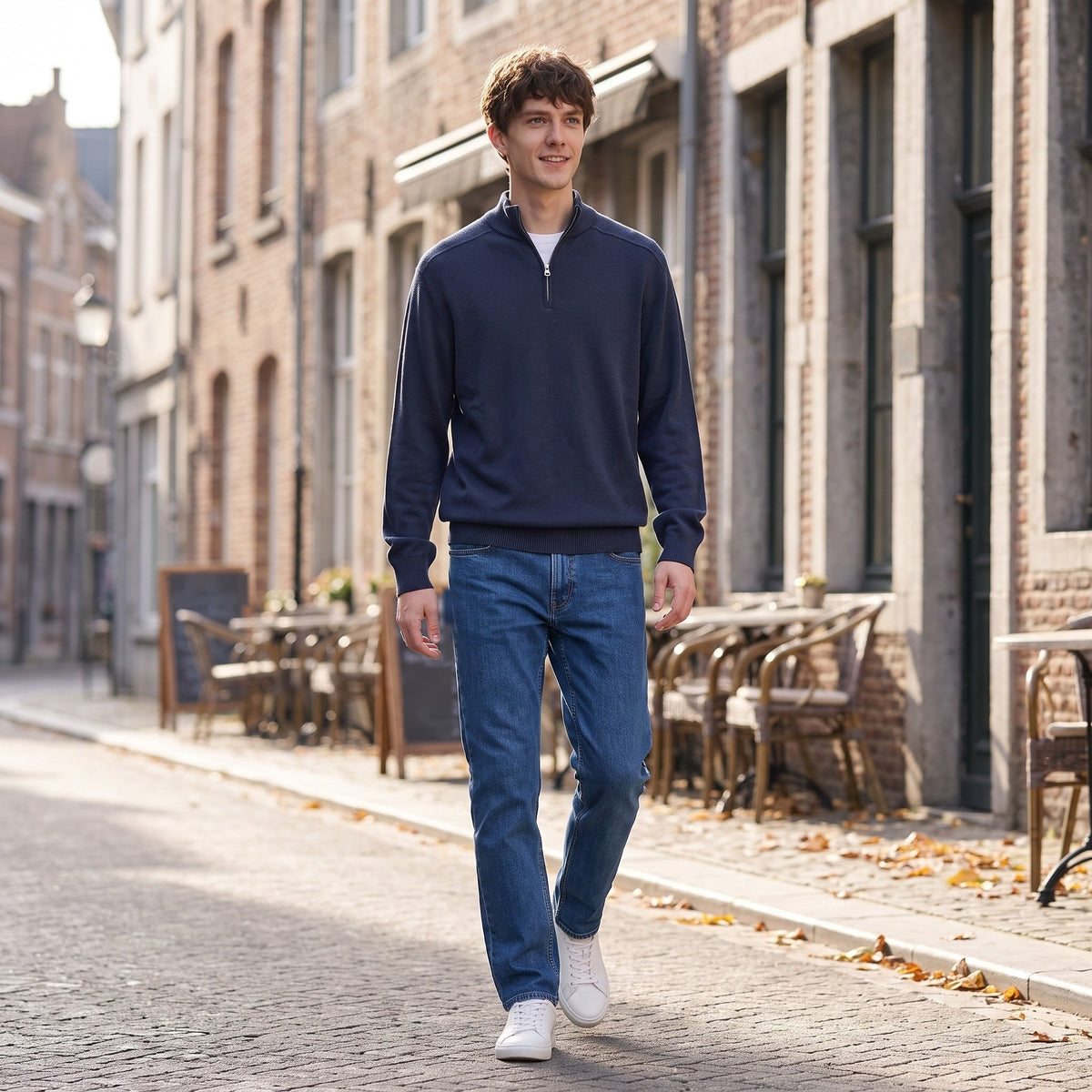 Man wearing navy half zip jumper walking on cobblestone street outdoors | Chaps London