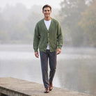Man wearing green ribbed cardigan with grey trousers on wooden dock | Chaps London