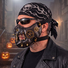 Black gold steampunk half mask with gears and spikes, worn by man | Chaps London