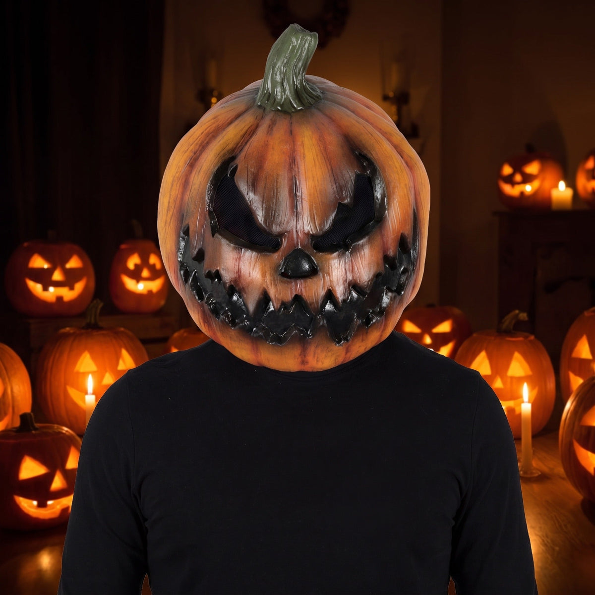 Person wearing an orange pumpkin head mask with menacing carved face | Chaps London
