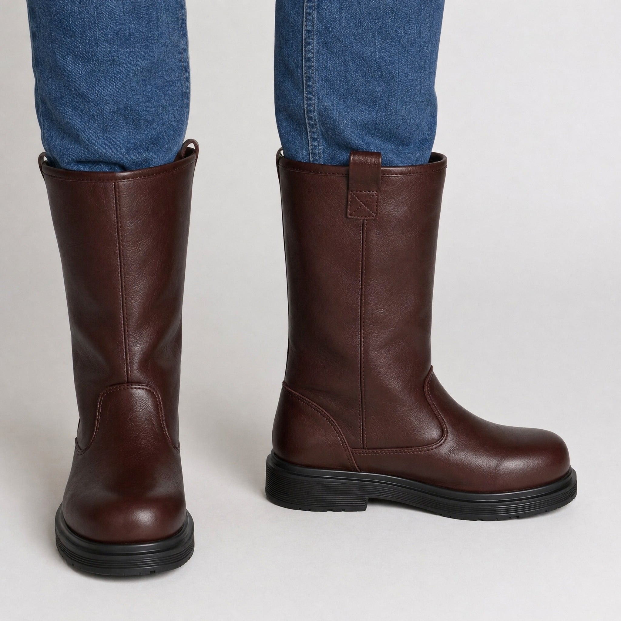 Brown leather mid-calf pull-on boots worn by a person, paired with jeans | Chaps London