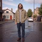 Man wearing khaki hooded jacket with jeans, standing on wet street | Chaps London