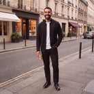 Man wearing black textured knit cardigan with white shirt on street | Chaps London