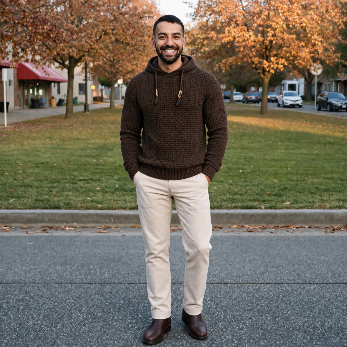 Man wearing brown basket weave knit hoodie with beige pants outdoors | Chaps London