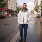 Man wearing white hooded jacket with jeans on city street | Chaps London