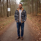 Man wearing gray plaid hooded shirt jacket with jeans outdoors | Chaps London