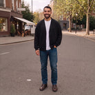 Man wearing black button-front cardigan jacket over white t-shirt, jeans, street setting | Chaps London