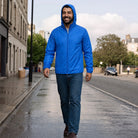 Man wearing blue hooded jacket with jeans, walking on street | Chaps London