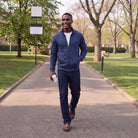Man wearing navy full-zip jacket with white shirt, walking in park | Chaps London