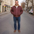 Man wearing maroon sherpa lined jacket with jeans on city street | Chaps London