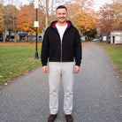 Man wearing black zip hoodie with plaid lined hood, standing outdoors | Chaps London