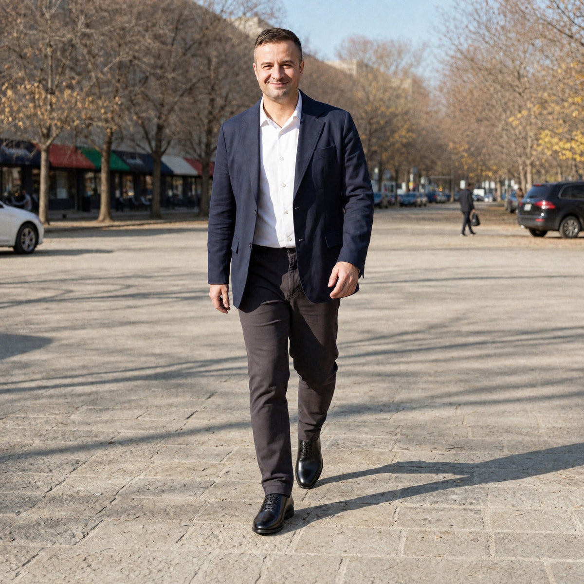 Man wearing black lace-up Oxford dress shoes while walking outdoors | Chaps London