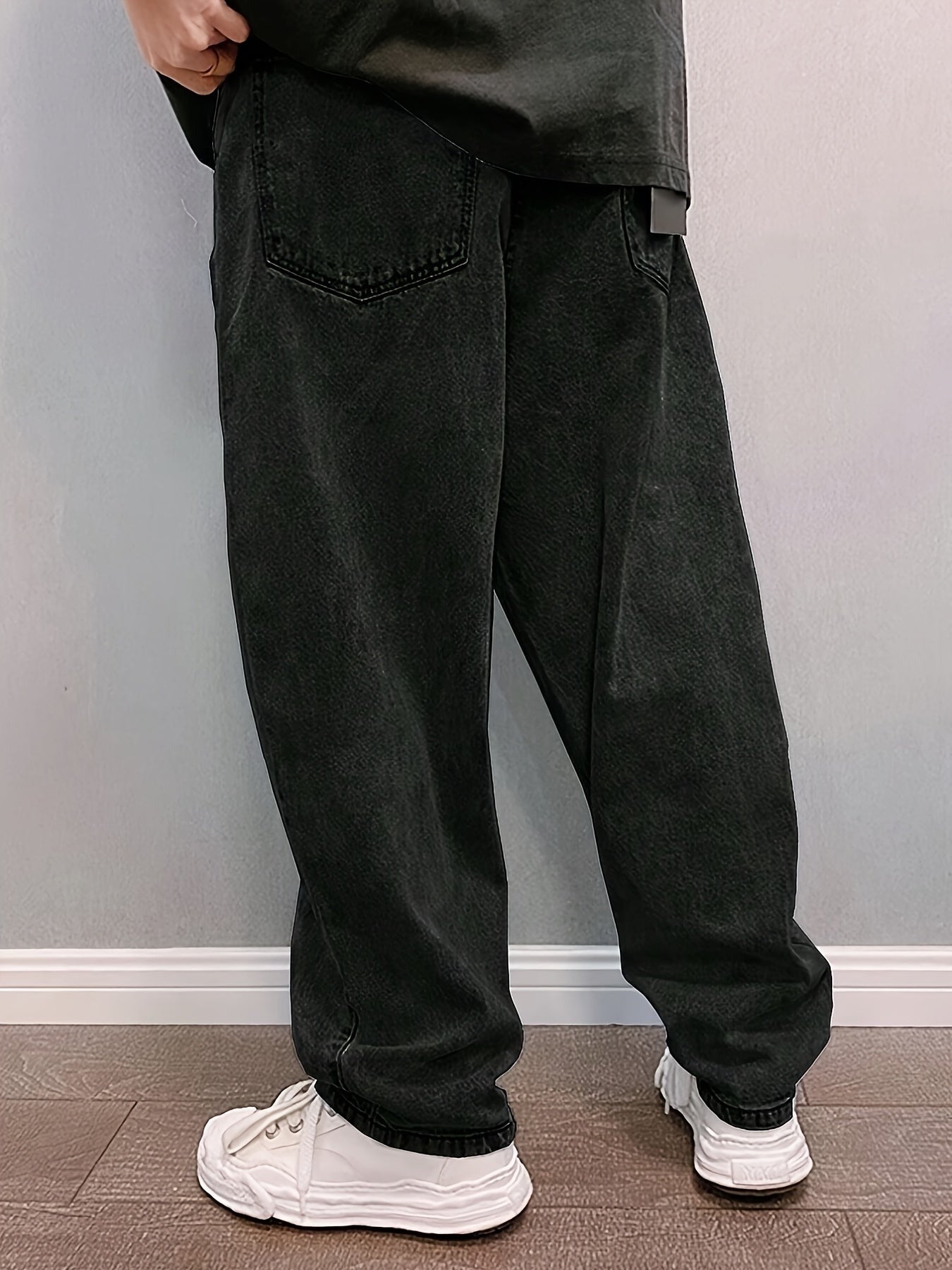 Men's baggy stonewash jeans in black, back view