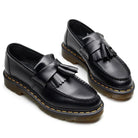 Pair of men's black chunky tassel loafers, front angled view from above