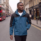 Man wearing the blue and black colour block rain jacket