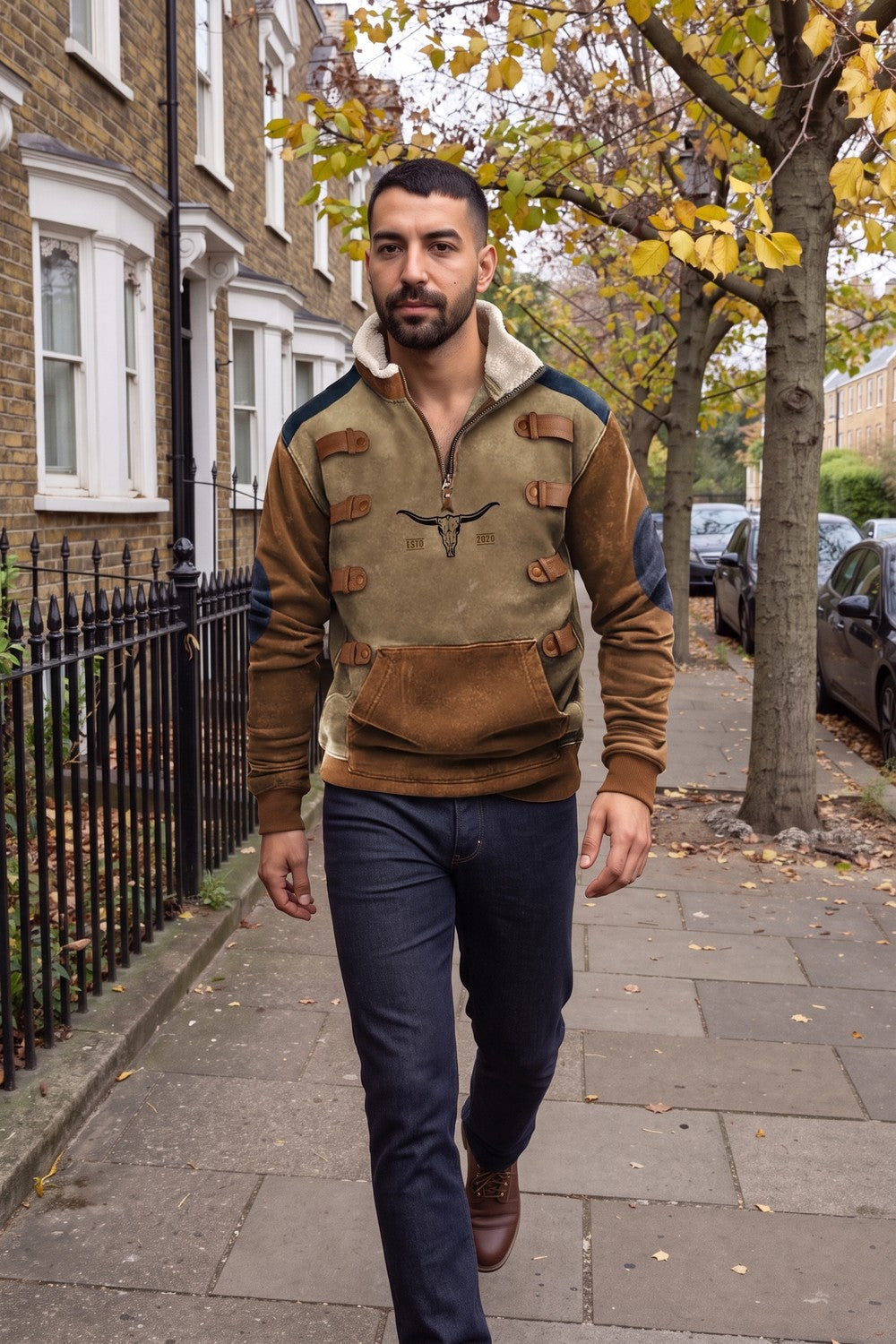 Man walking on a London street in a khaki half-zip fleece pullover with a sherpa collar, dark jeans and brown boots