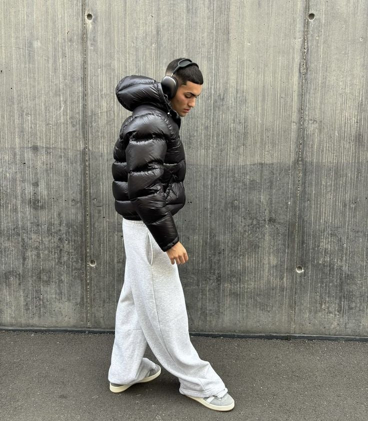 Black high-shine hooded puffer jacket, side view