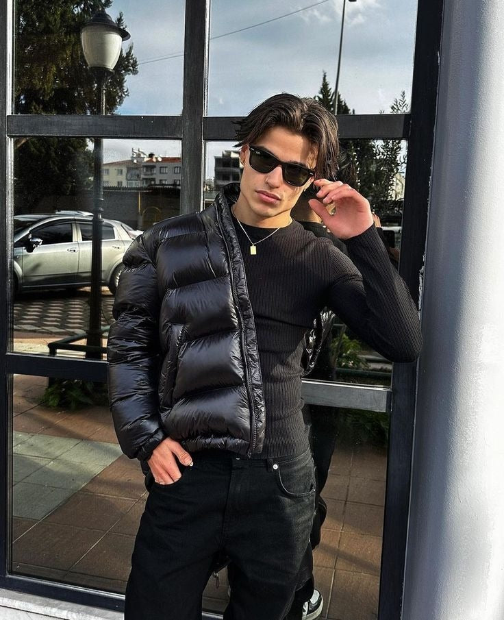 Black shiny puffer jacket worn open with sunglasses
