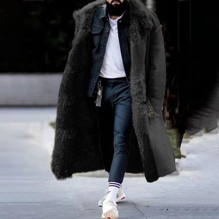 Man wearing black faux fur lined long coat, denim jacket, and jeans outdoors | Chaps London