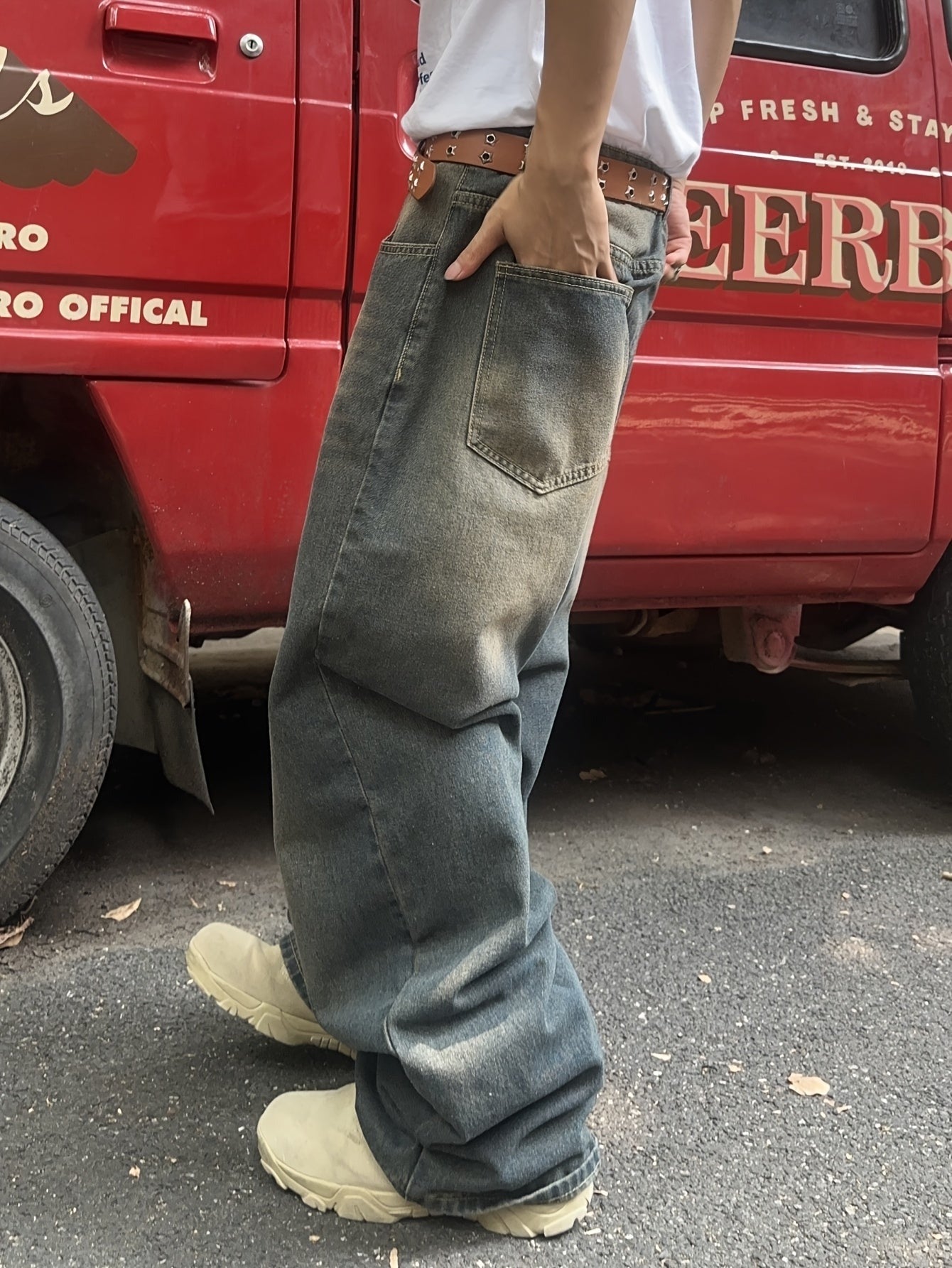 Men's baggy wide leg jeans in a vintage wash, side view