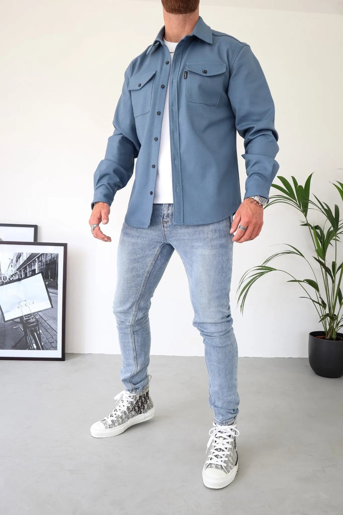 Men's blue button-up overshirt with chest pockets