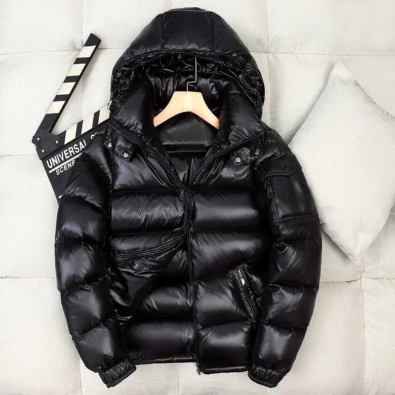 Black shiny hooded puffer jacket on hanger, displayed against pillows | Chaps London