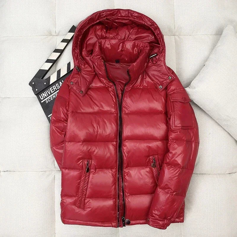Red shiny puffer jacket with hood, laid flat beside clapperboard | Chaps London