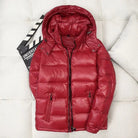 Red shiny puffer jacket with hood, laid flat beside clapperboard | Chaps London