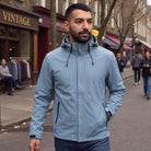 Man wearing the light blue rain jacket with hood