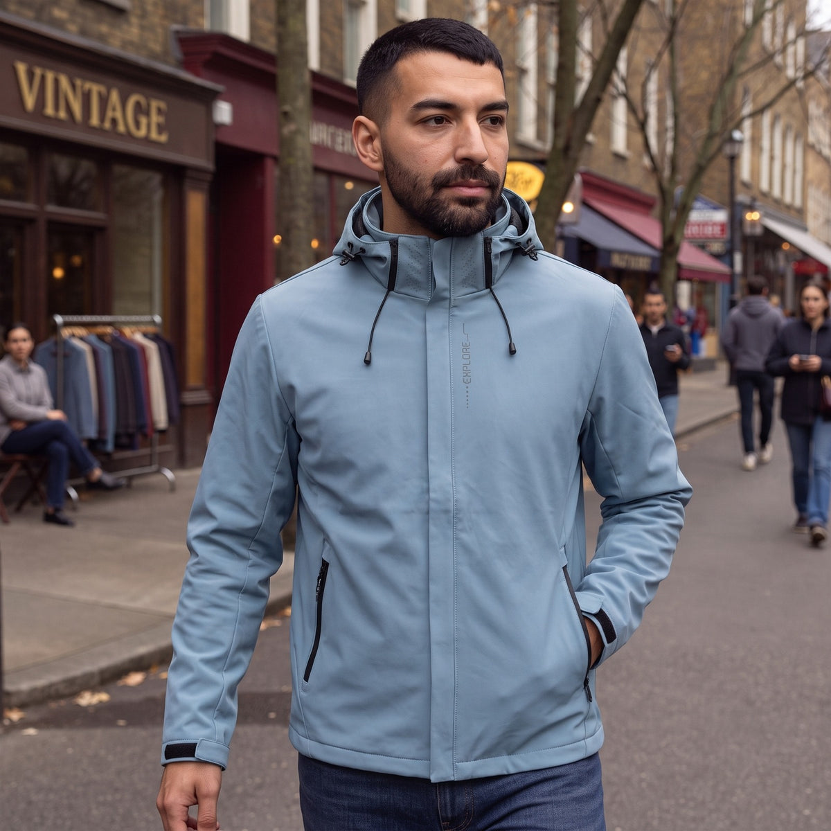 Man wearing the light blue rain jacket with hood