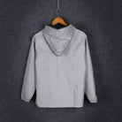 Reflective rain jacket on a hanger, back view with hood
