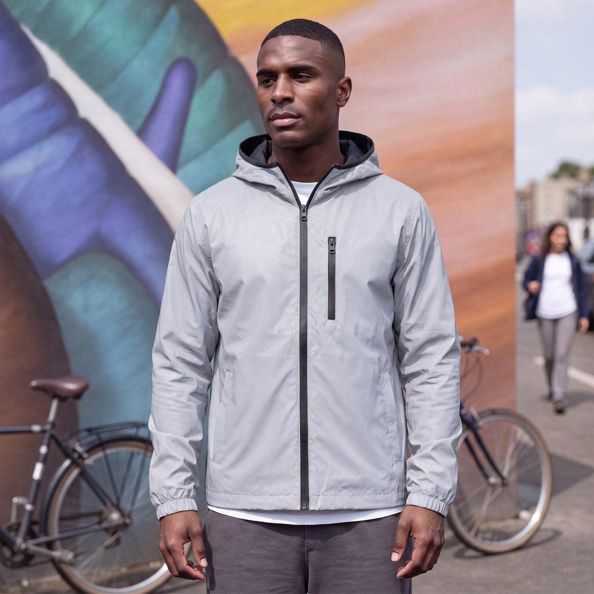 Man wearing the silver grey reflective rain jacket