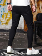 Men's black skinny jeans, back view
