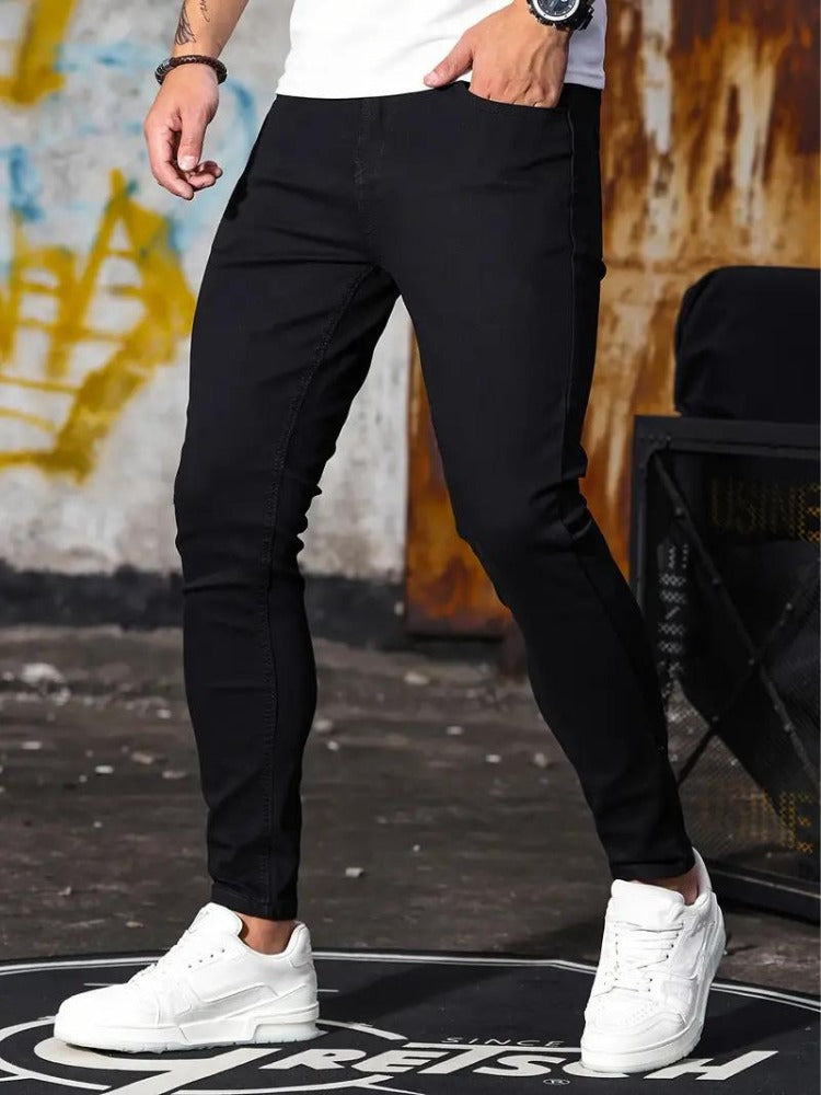 Men's black skinny jeans with white trainers