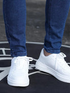 Close-up of the ankle on the blue skinny jeans