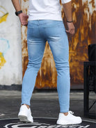 Men's light blue skinny jeans, back view