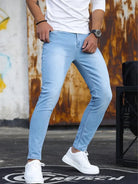 Men's light blue skinny jeans with white trainers