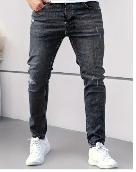 Black distressed skinny jeans worn by man with white sneakers | Chaps London