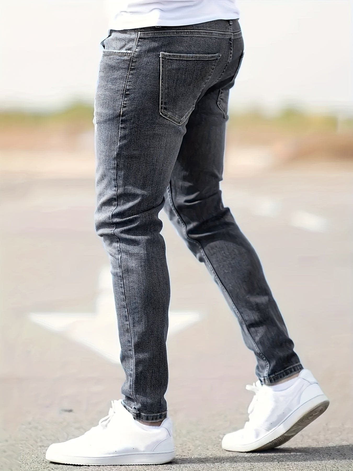 Man wearing gray slim fit denim jeans with white sneakers outdoors | Chaps London