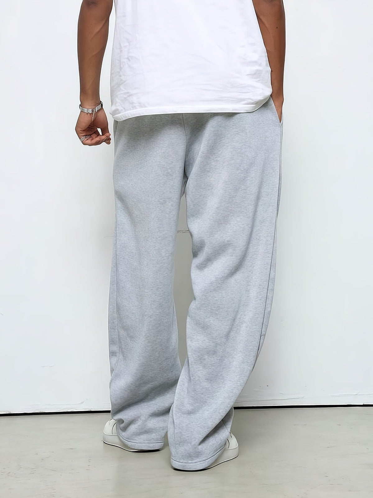Man wearing gray fleece straight-leg joggers, rear view, standing indoors | Chaps London