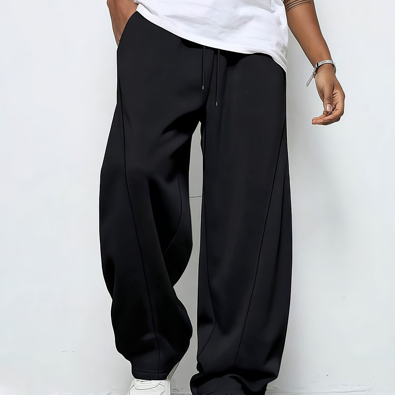 Black straight-leg drawstring joggers worn by a man, front view | Chaps London