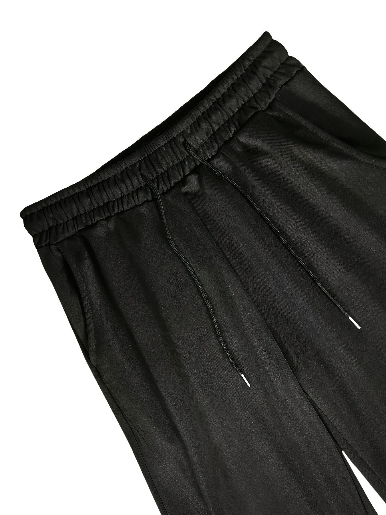 Black jersey joggers with elastic waistband and drawstring, close-up flat view | Chaps London