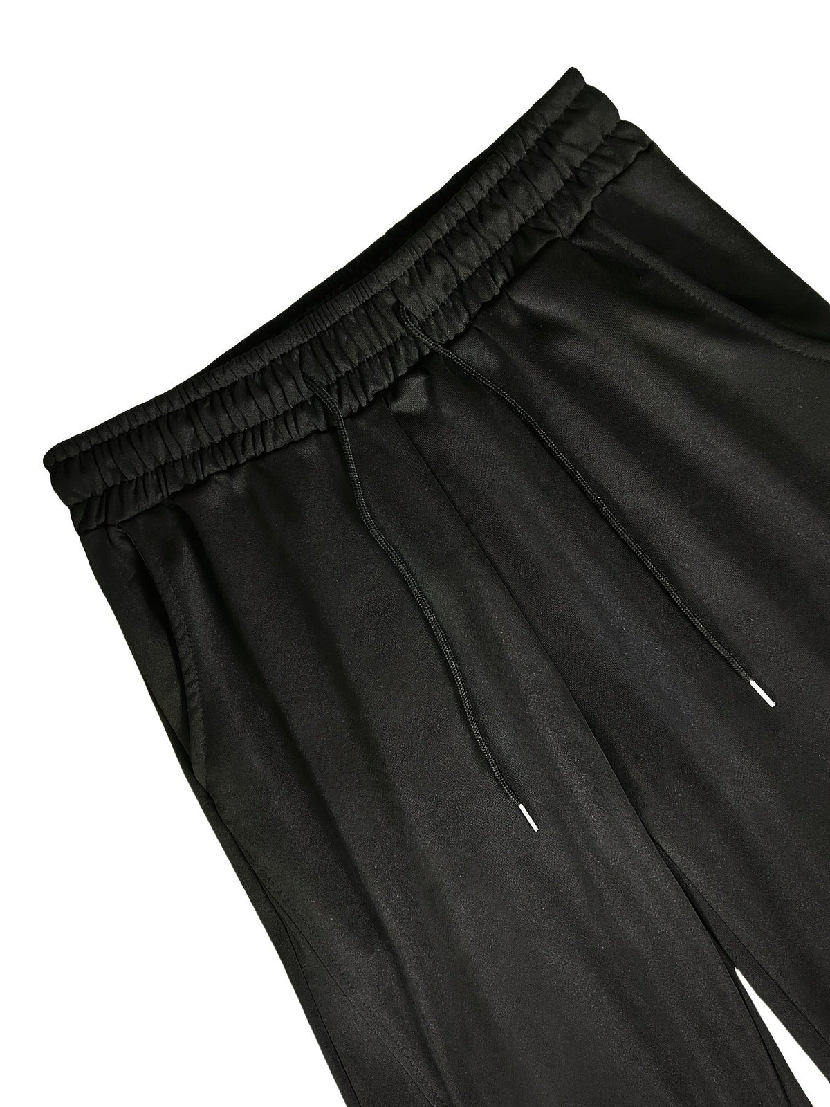 Black jersey joggers with elastic waistband and drawstring, close-up flat view | Chaps London